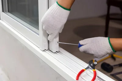 Sliding Door Roller Replacement - PSL Sliding Door Repair - Boca Raton & Palm Beach Area Technician replacing worn rollers on a sliding door for smoother operation